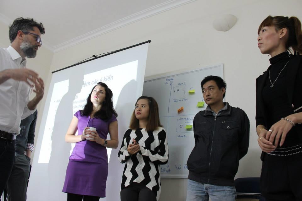 Projects Abroad International Development Interns discussing fundraising in an business office during International Development work experience in Vietnam. A group of International Development interns discuss plans of fundraising before presenting to work place during an Internship in Vietnam.